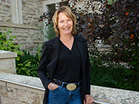 Dr. Shelley Kirychuk. A white woman with short hair, stands outside the USask Health Sciences building.